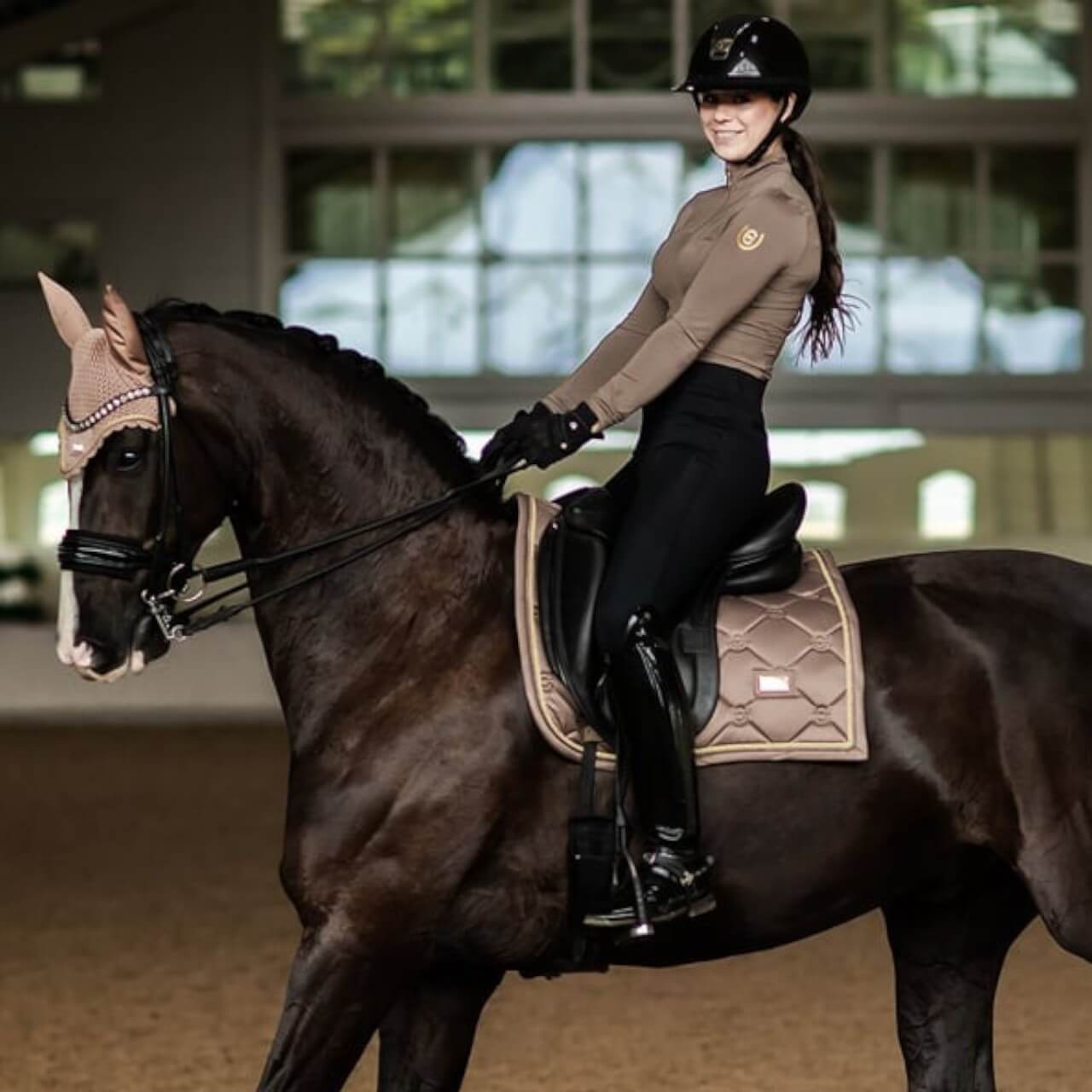 Reithose Damen Full-Grip Compression Supreme Dressur Hose, schwarze Reithose, Reiterin auf Pferd in der Reithalle.